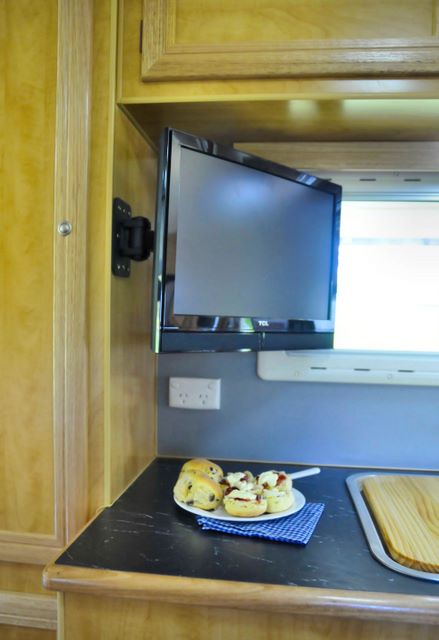 Airflow Caravans - Cabarlah: Airflow Caravans: Interior showing TV and kitchen top.