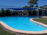 Wangaratta Caravan Park - Bowen: Swimming Pool and Camp Kitchen behind the Pool