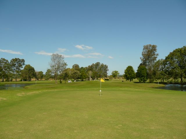 Mullumbimby Golf Course - Mullumbimby: Green on Hole 12 looking back along the fairway.