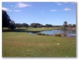 The Colonial Golf Course - Robina Gold Coast: Fairway view on Hole 4 - you need to hit across the water to reach the green.