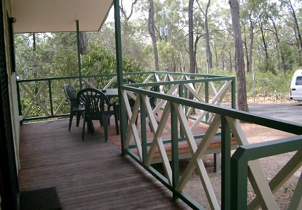 Capricorn Caves Tourist Park - Rockhampton: Cabin deck with views of the bush