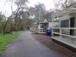 Brownhill Creek Tourist Park - Mitcham: Basic cabins front the creek and picnic tables.