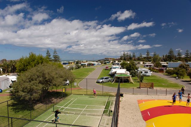 BIG4 Adelaide Shores Caravan Resort - West Beach: Tennis area, jumping pillow and park overview.