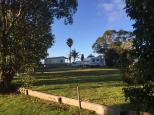 Bega Caravan Park - Bega: Overview of powered sites and cotage accommodation at the rear of the park.