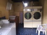 Bega Caravan Park - Bega: Interior of laundry showing washing machine is in very large driers.