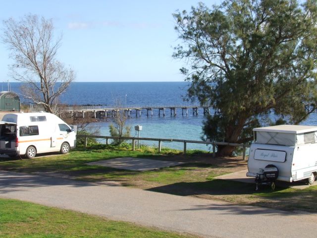 Powered sites for caravans with water views.