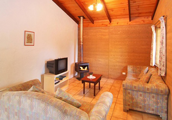 Sandy Bay Holiday Park - Busselton: Living area in Rammed Earth Chalet