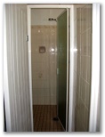 Cowra Van Park - Cowra: Amenities shower recess with glass screen.