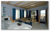 Joalah Holiday Park - Durras North: Lounge room in Waterfront and Waterview Deluxe Cabin