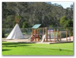 Discovery Holiday Park - Eden: Play area for children with tennis courts in the background