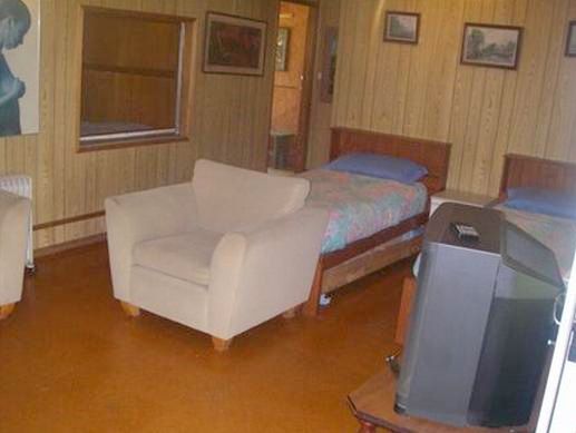 Riverlands Caravan Park and Wombat Cafe - Gunderman: Cabin lounge room showing two single beds