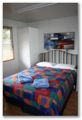Sapphire City Caravan Park - Inverell: Interior of cabin showing main bedroom