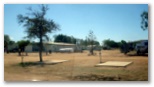 Longreach Tourist Park - Longreach: Powered sites for caravans with amenities block in the background