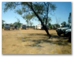 Longreach Tourist Park - Longreach: Powered sites for caravans with some shade from a tree.