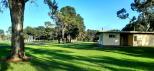 Lucindale Caravan Park - Lucindale: looking down past the toilet block to the back of the park.