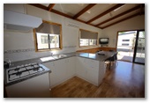 Sun Country Holiday Village - Mulwala: Interior of cottage showing kitchen and dining room.