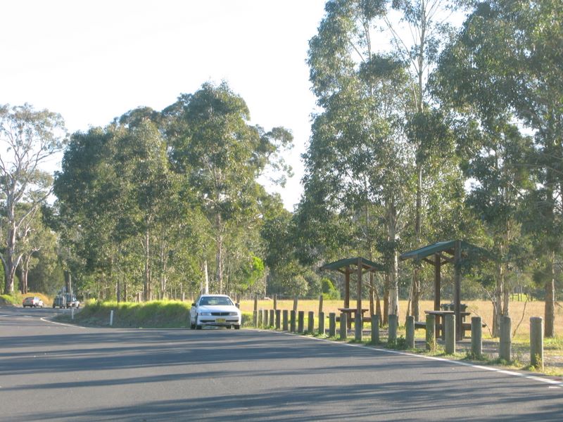 Bewong Rest Area - Bewong: Large sealed area for parking with picnic shelters on right