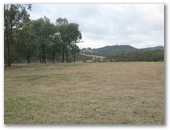 Sofala Showground Entrance - Sofala: View of the parking area with mountains in the distance.