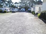 Discovery Holiday Parks  - Strahan: Cabins for singles and families, showing good gravel roads.