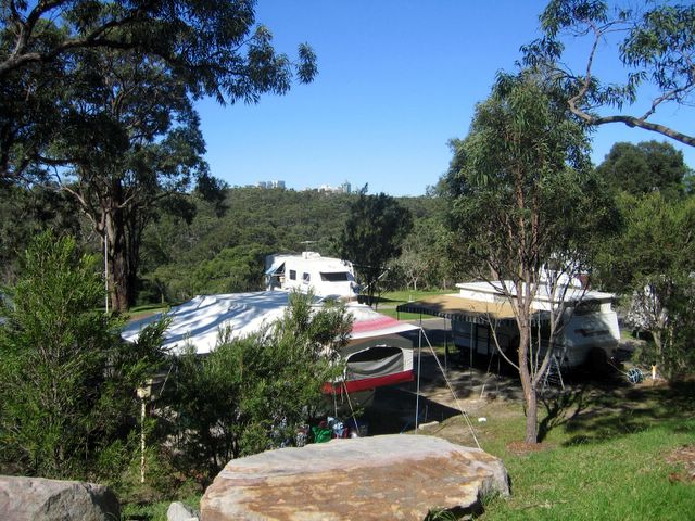 Lane Cove River Tourist Park - Macquarie Park: Powered sites for caravans with city view in the background