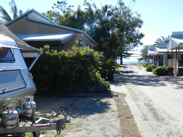 Woodgate Beach Tourist Park - Woodgate: Powered sites and cabin showing beach in background