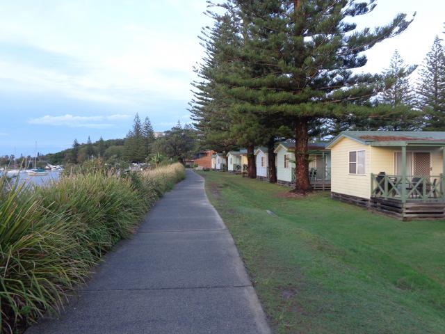 Calypso Holiday Park - Yamba: River side cabins with walking track in front 