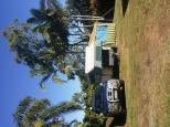 Poinciana Tourist Park - Yeppoon: Seperate grass area for larger vans meant we were able to hide away from the  main crowd in a shady secluded corner, but still with a clean shower block only a few steps away